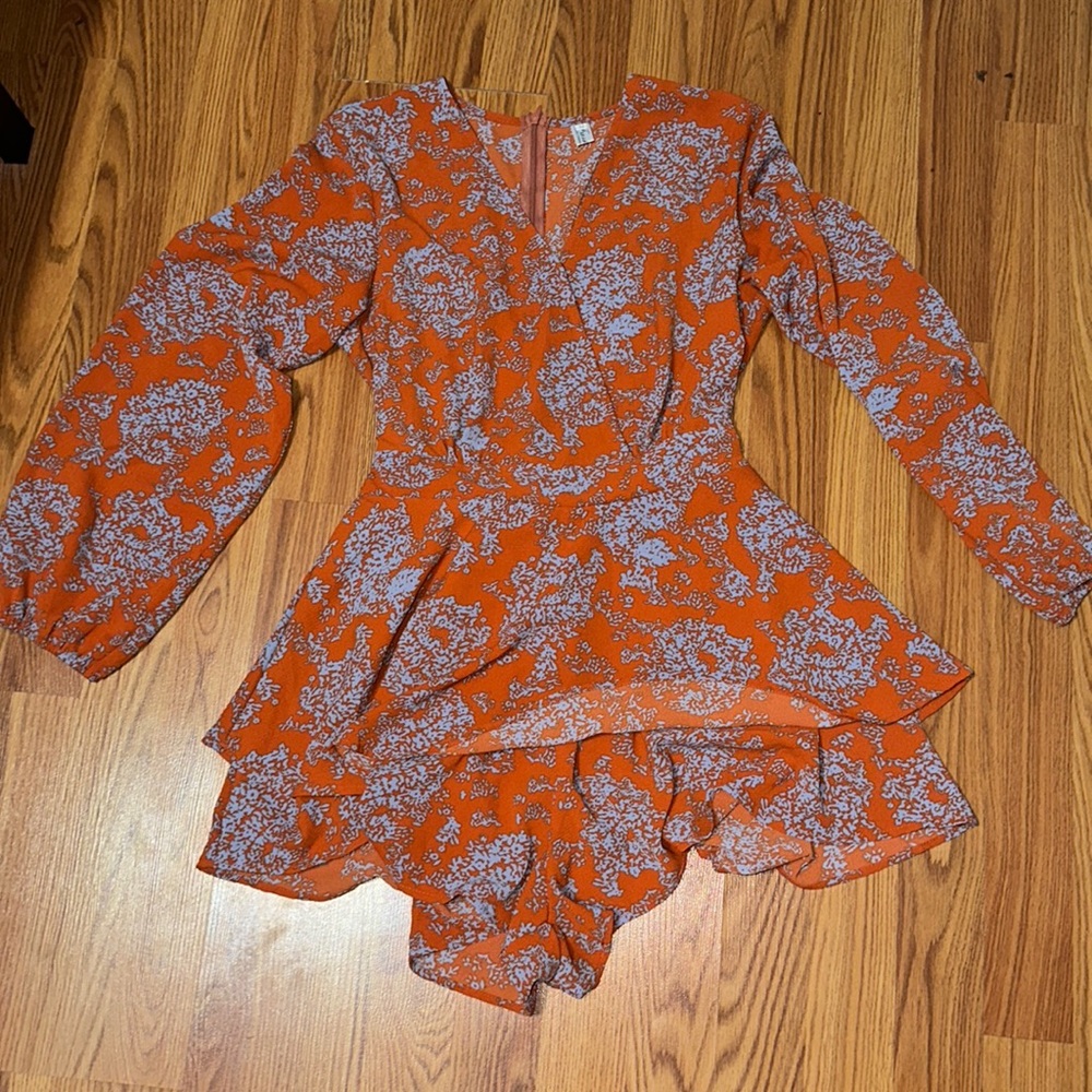 A burnt orange and light blue romper. Never worn, but has no tags.